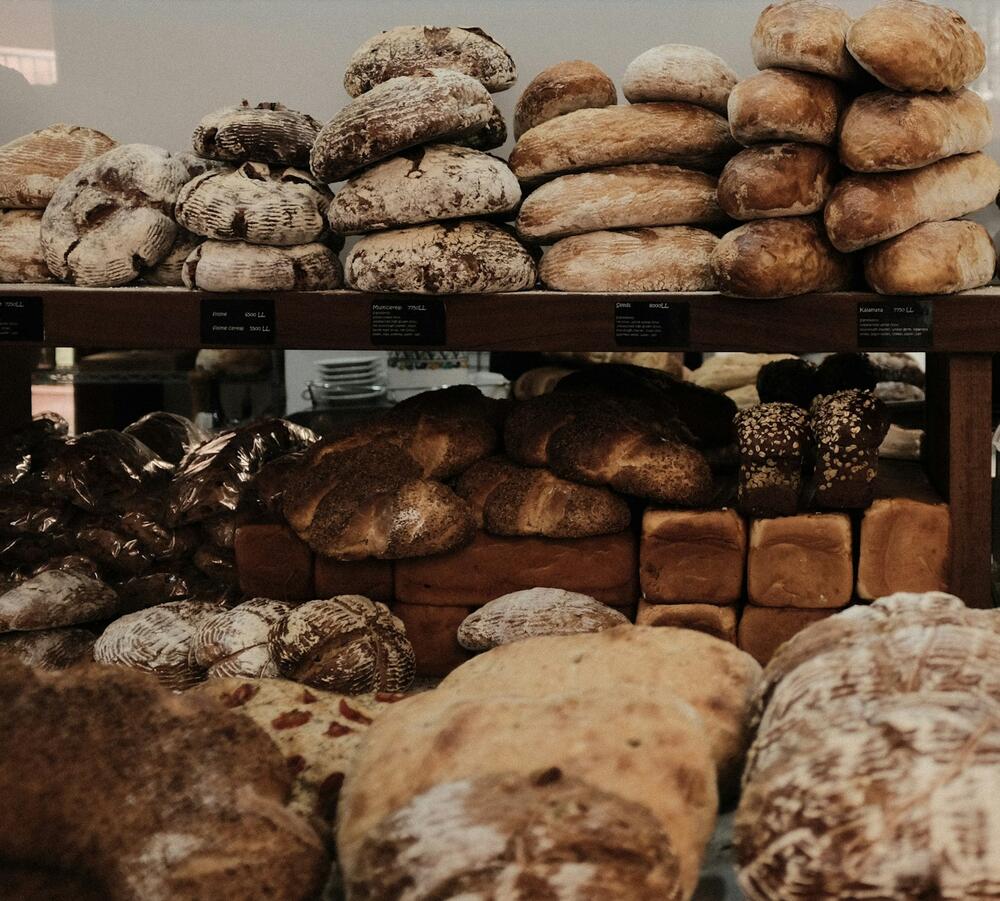 Shelves of round sourdough and rye loaves, dusted with flour